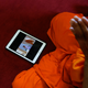 The coronation streams on a monk’s tablet as he prays.